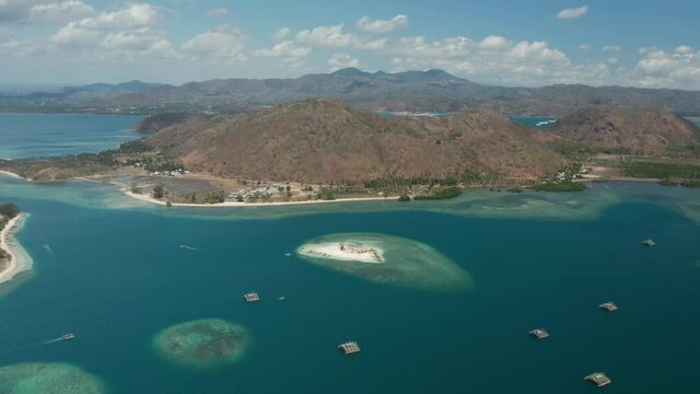Aerial of Lombok shore with traditional floating fishermen instruments in bay