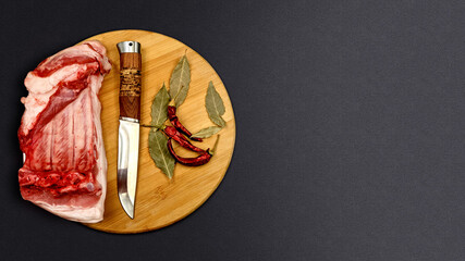 Pork meat hunter knife and spaces on desk