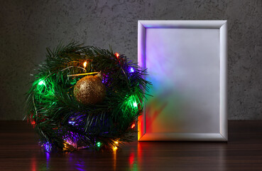 Festive background with Christmas tree branches in the form of ball with garlands and empty white...