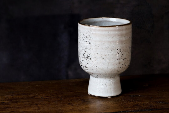 One ceramic vase on a dark background