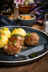 Meatballs with cheese served with boiled potatoes.