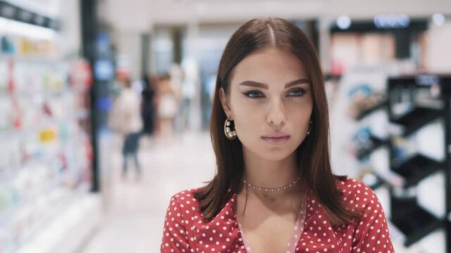 Portrait of beautiful serious young caucasian female shopper 