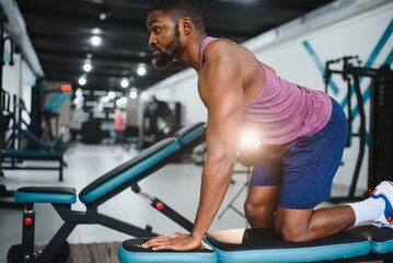 Fototapeta na wymiar Portrait african american bodybuilder at gym intense intimidating glare expression conviction