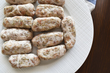Uncooked Sheftalia: Cypriot Lamb and Pork Sausages on a White Plate. Traditional Cypriot food. 