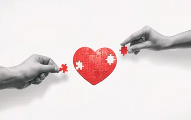 Poster Two people put together a heart-shaped puzzle. The concept of building love relationships. © svetazi