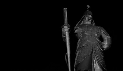 Statue of Korean Admiral Yi Sun Shin against black. 