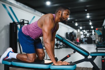 Fototapeta na wymiar Weight training African doing bodybuilding in gym