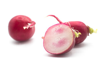 Closeup of cutted organic radishes on white background