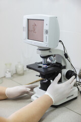 A scientist works with an electron microscope.