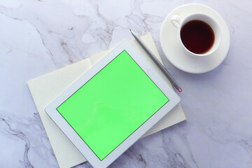 Flat composition of digital tablet and office stationary on tiles background 