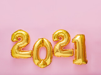 2021 balloon text on pink background. Happy New year eve invitation with Christmas gold foil balloons 2021.Square flat lay with copy space.
