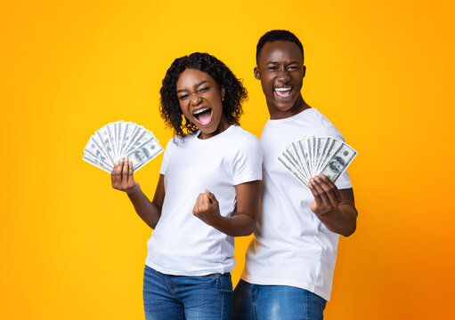 Emotional Black Couple Holding Bunch Of Money