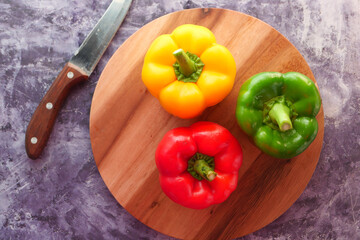 Yellow orange and red capsicum on black background 
