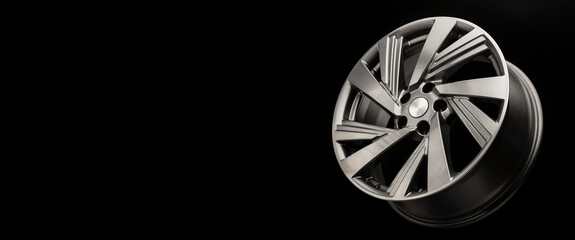 beautiful new alloy wheel on a black copyspace background, long layout concept for auto sites and...