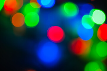 Abstract pattern of colorful bokeh lights on dark background