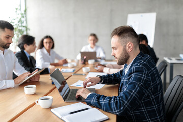 Businessman Using Laptop Working During Corporate Meeting In Modern Office