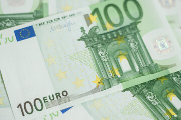 100 euro bill. Europein money banknote. Hundred euro bills on wooden background..