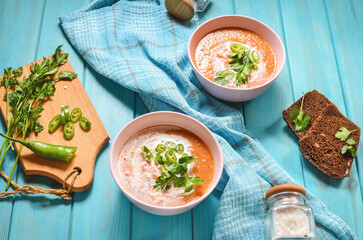Red lentil tomato soup - delicious vegetarian food on wooden background. Healthy lunch