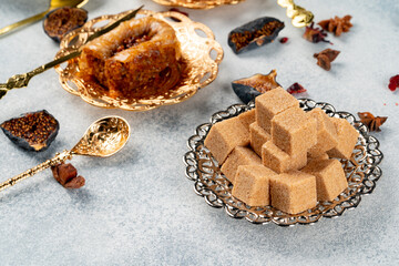 Silver plate with lumps of sugar on table