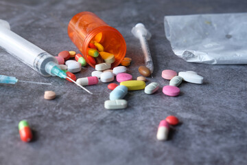 syringe , pills and capsules on table 