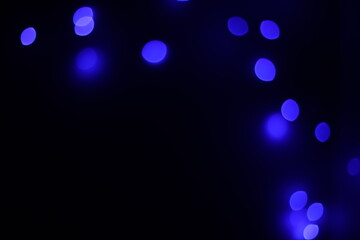 Background of blue bokeh (led strip light in a 50mm lens) on a dark black background.  Design elements