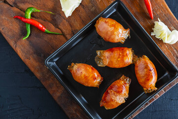 Homemade sausages  fried in a frying pan
