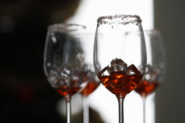 Many glasses with ice and whiskey standing on table in restaurant close-up