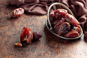 Dried sweet dates on an old brown table.