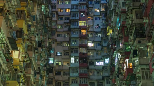Hong Kong, China, zoom out time lapse view of high rise residential buildings at dusk. Hong Kong is one of the most densely populated places in the world.