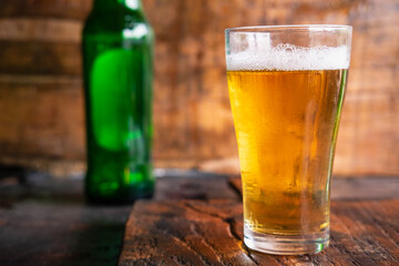 Beer mugs and beer bottles on a wooden table
