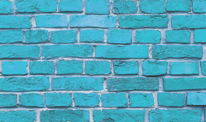 The wall of the building is made of old blue bricks and white cement. Background.