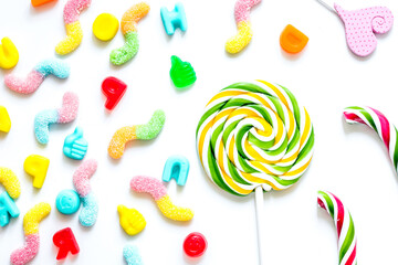 Colorful candies on white texture background top view pattern