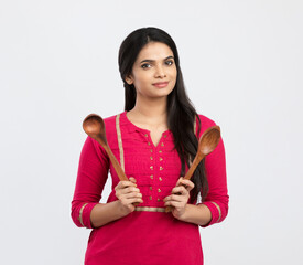 Cheerful Indian woman holding wooden skimmer on white.