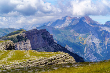 Green landscape in the Pyrenees of the Ordesa and Monte Perdido valley with mountains, rocks, forests and sky with clouds. Top aerial view.
