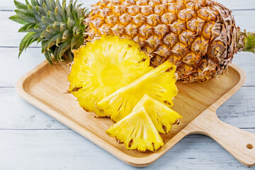 Pineapple fresh fruit on wooden plate