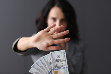 Business woman with hand refusing offered money closeup