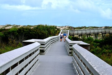 People walking on the boardwalk to the ocean beach St. Augustine, Florida