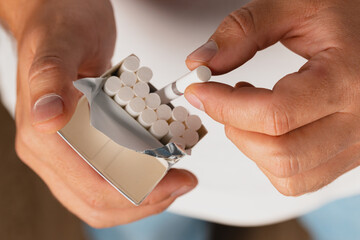 Male taking out cigarette from cigarette pack