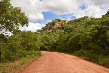 Dirt road and rock formation in a national park in Zimbabwe