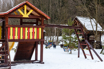 Fototapeta na wymiar Playground in winter with snow