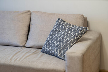 Contemporary interior of living room. Close-up of cozy sofa with soft cushions.