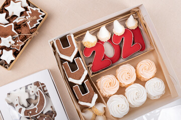 Gingerbread, gingerbread houses and marshmallows in christmas box. Holiday baked goods