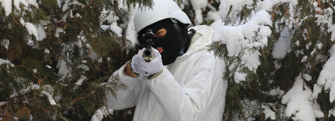 military sniper with a sniper rifle in the winter forest