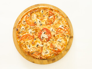 whole pizza on a wooden stand on a white background