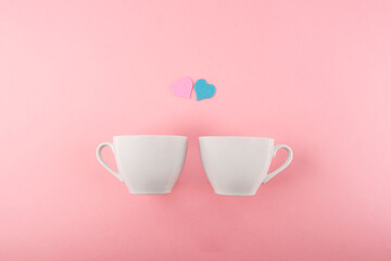 Two cups of coffee on a pink background. Valentine's day concept.