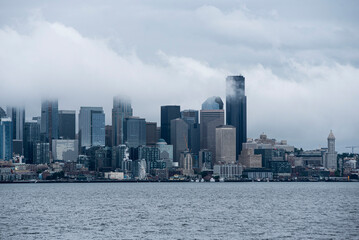 Fototapeta na wymiar foggy cloudy view of seattle skyline from the harbor