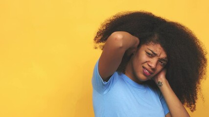 Young african american curly woman covering ears with hands