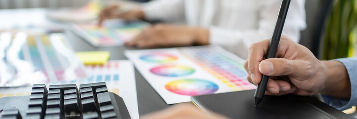 Creative graphic designer team working with colour swatch sample, Brainstorming ideas in studio..