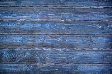 A beautiful blue universal natural background from textured coniferous wooden boards. Aged boards by firing and brushing