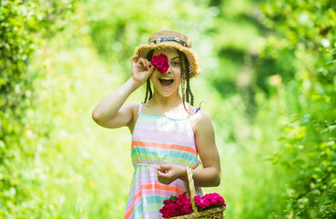 Beautiful paradise. Beautiful girl in straw hat collect roses. happy childhood. beautiful girl with flowers. little girl holding pink fresh blossoming flower bouquet of roses. flower composition